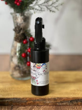 Load image into Gallery viewer, Black spray bottle with a label on a wooden surface with a blurred background