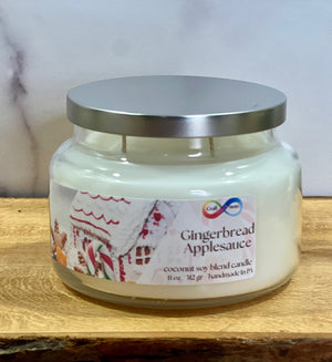 Jar of 'Gingerbread Applesauce' candle with a decorative label on a wooden surface. Jar of 'Gingerbread Applesauce' candle with a decorative label on a wooden surface.