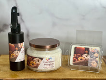 Load image into Gallery viewer, Candle products including a bottle, jar, and wax melt on a wooden surface with a neutral background.