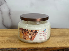 Load image into Gallery viewer, Candle jar labeled 'Maple Leaf & Acorn' on a wooden surface with a marble background