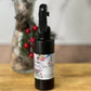 Black spray bottle with a label on a wooden surface with a blurred background