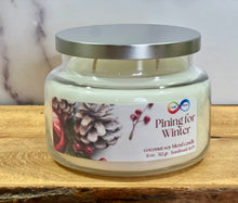 Load image into Gallery viewer, Candle jar labeled &#39;Pining for Winter&#39; on a wooden surface with a white background
