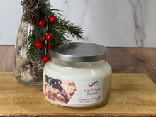 Load image into Gallery viewer, Candle jar labeled &#39;Sugar Plum Danish&#39; with decorative elements on a wooden surface
