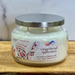 Jar candle labeled 'Gingerbread Applesauce' on a wooden surface with a white background