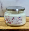 Jar candle labeled 'Gingerbread Applesauce' on a wooden surface with a white background