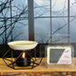 Aroma lamp with a candle and a package of dark orchard incense on a wooden surface.