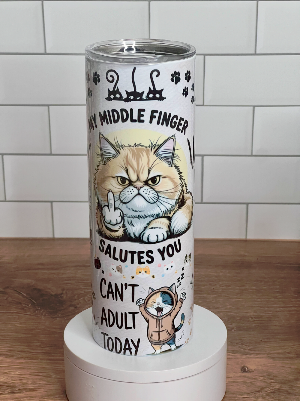 Tumbler with a cat illustration and humorous text on a white background